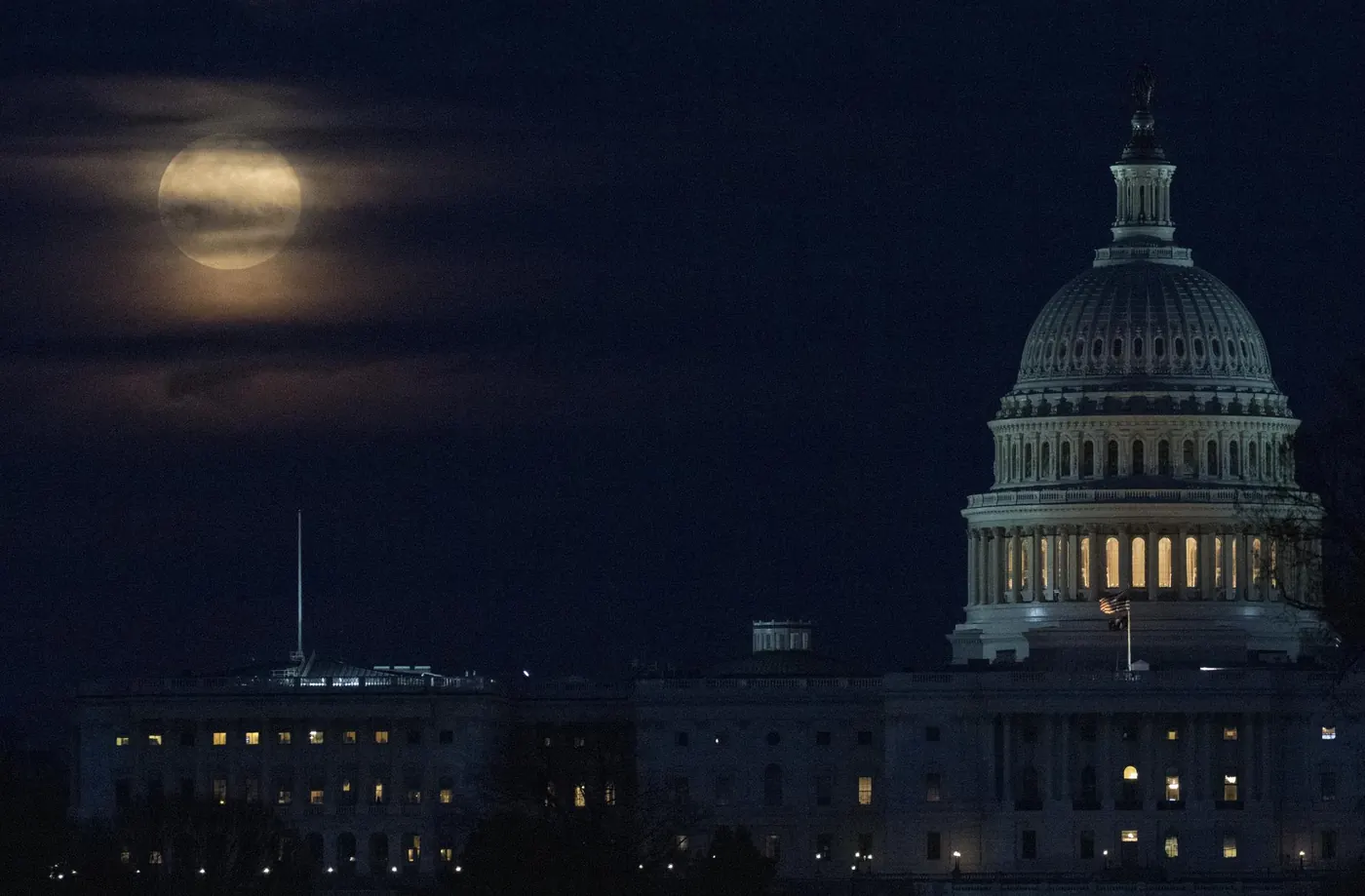 Washington'daki Kongre binasının yanında, bulutlar arasında yükselen süper ay